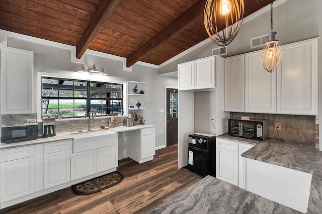 kitchen featuring dark hardwood / wood-style flooring, sink, lofted ceiling with beams, decorative light fixtures, and white cabinetry