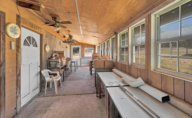 unfurnished sunroom featuring ceiling fan, wood ceiling, and lofted ceiling