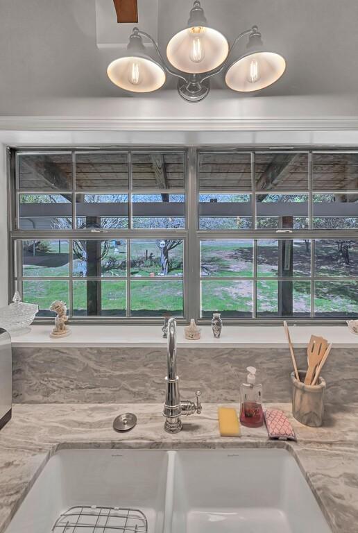 interior details featuring light stone counters and sink