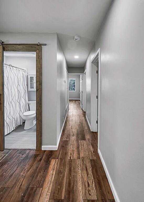 hallway with dark hardwood / wood-style floors