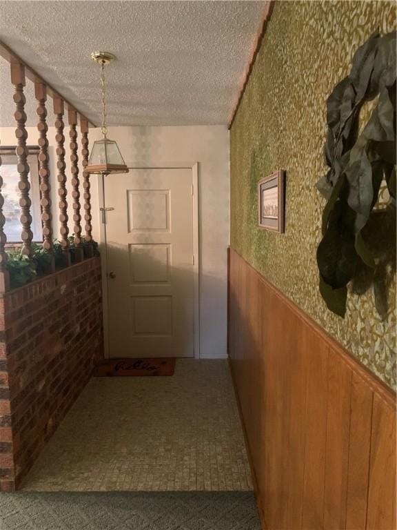 wine cellar with wood walls and a textured ceiling