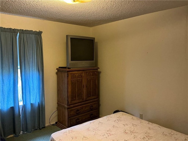 carpeted bedroom featuring a textured ceiling