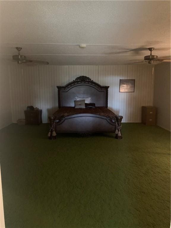 unfurnished bedroom featuring ceiling fan, carpet floors, and a textured ceiling