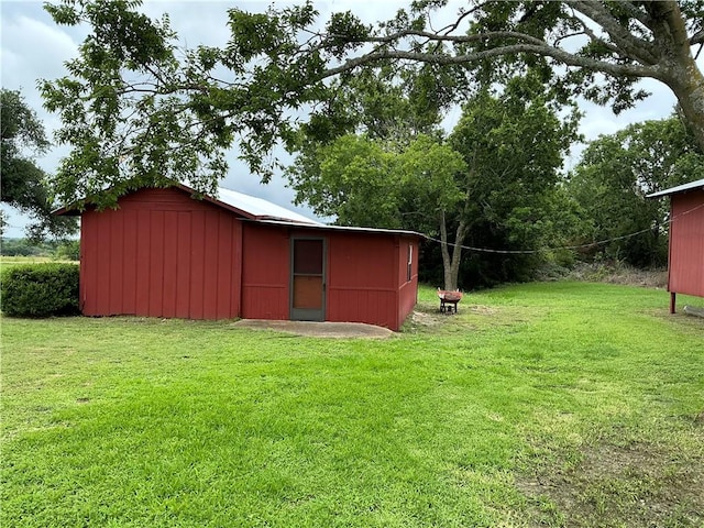 view of outbuilding featuring a yard