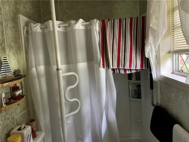 bathroom with radiator heating unit and walk in shower