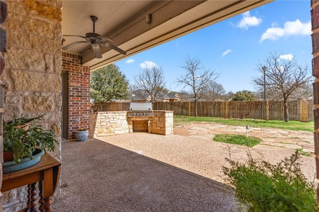 view of patio with grilling area, an outdoor kitchen, a fenced backyard, and ceiling fan