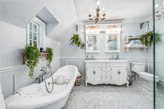 bathroom with vanity, an inviting chandelier, toilet, a textured ceiling, and a tub to relax in