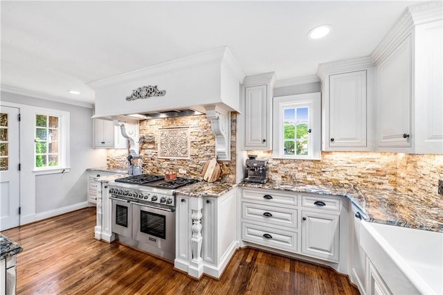 kitchen with double oven range, dark hardwood / wood-style flooring, and white cabinetry