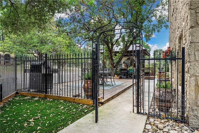 view of gate with a wooden deck