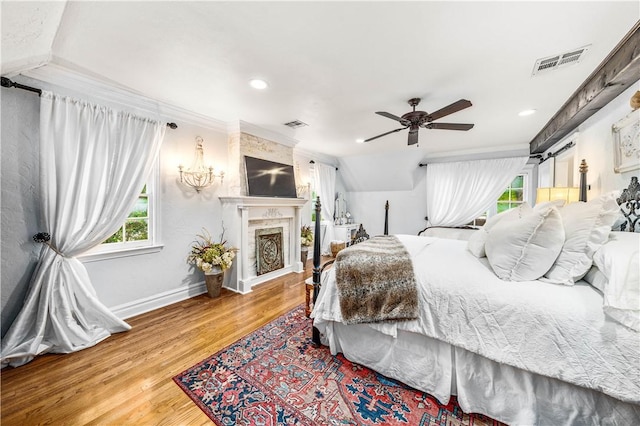 bedroom featuring ceiling fan, wood-type flooring, and lofted ceiling