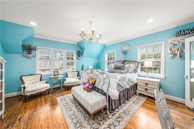 bedroom featuring hardwood / wood-style flooring, crown molding, and a chandelier