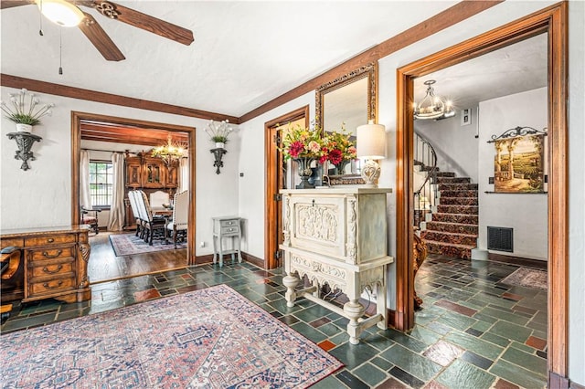 living room featuring ceiling fan with notable chandelier, crown molding, and dark wood-type flooring