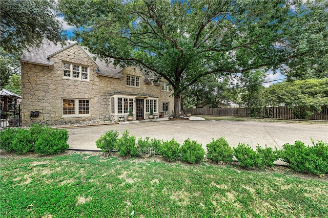 back of house featuring a patio area and a yard