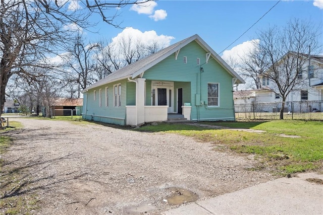 bungalow-style home featuring fence and driveway