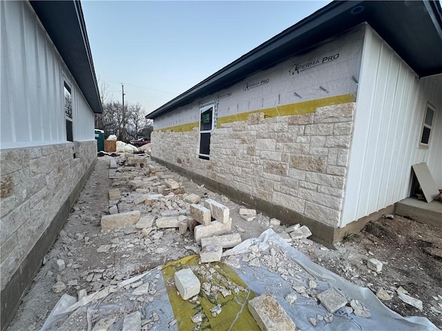 view of side of property featuring stone siding