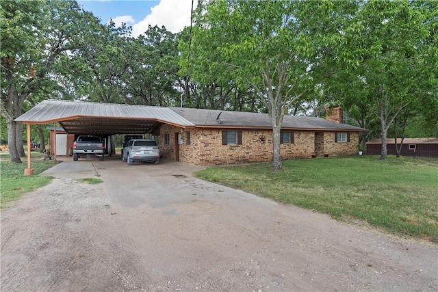 single story home featuring a carport and a front lawn