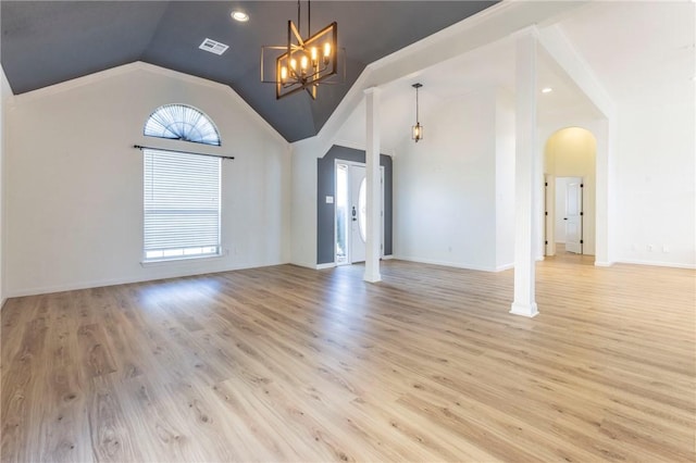 unfurnished living room featuring a notable chandelier, high vaulted ceiling, and light wood-type flooring