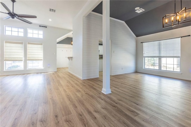 unfurnished living room featuring ceiling fan, lofted ceiling, and light wood-type flooring