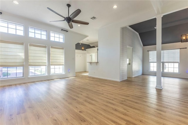 unfurnished living room featuring plenty of natural light, ceiling fan, and light hardwood / wood-style flooring