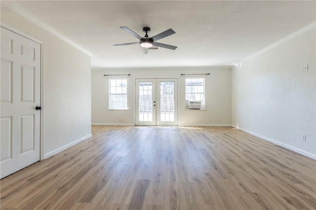 empty room with ornamental molding, light hardwood / wood-style floors, french doors, and a healthy amount of sunlight