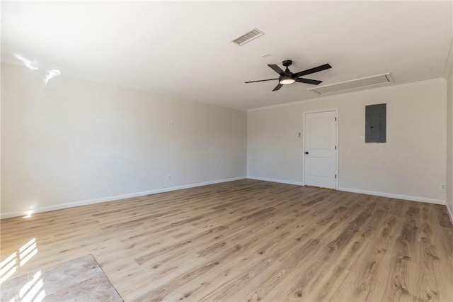 spare room featuring ceiling fan, ornamental molding, electric panel, and light wood-type flooring