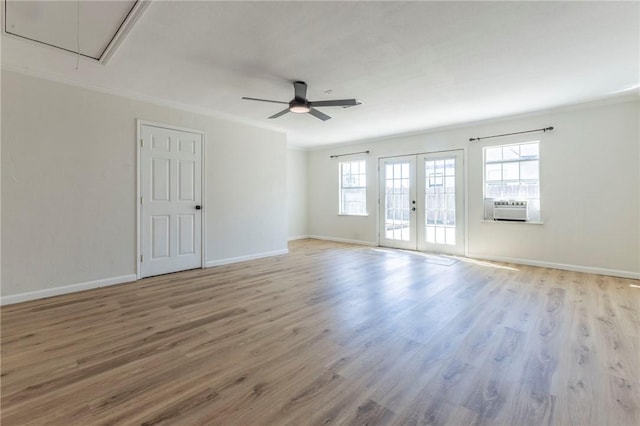 unfurnished room with crown molding, french doors, and light wood-type flooring