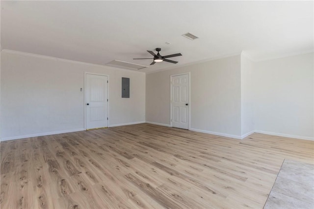 spare room with ceiling fan, ornamental molding, electric panel, and light wood-type flooring