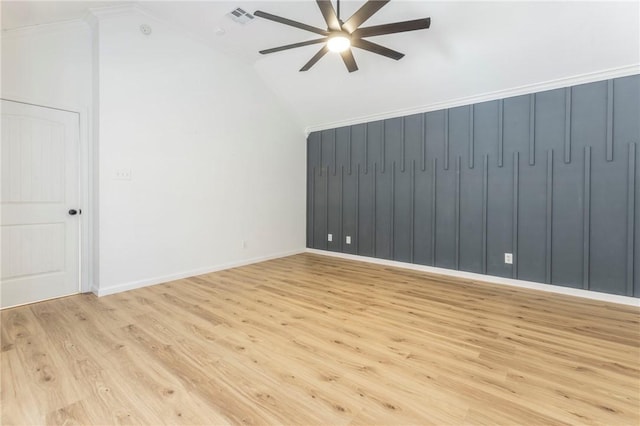 empty room featuring ceiling fan, lofted ceiling, and light hardwood / wood-style flooring