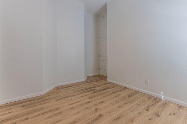 empty room with light hardwood / wood-style flooring