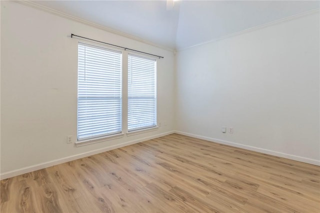 spare room featuring vaulted ceiling and light hardwood / wood-style floors