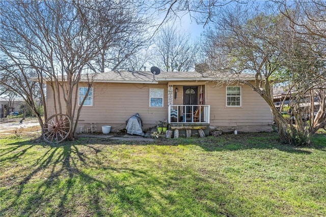 back of house with a lawn