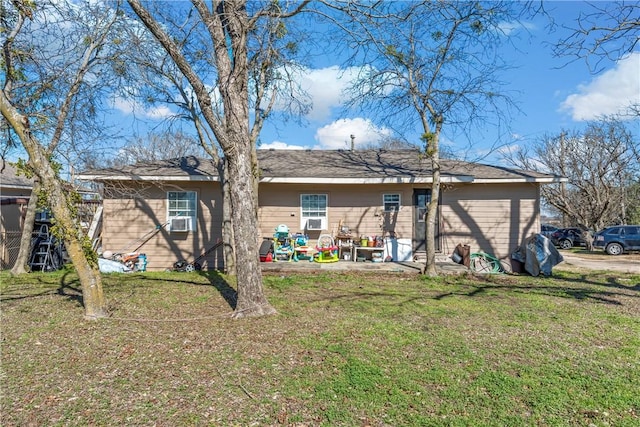 rear view of house with a yard, cooling unit, and a patio area