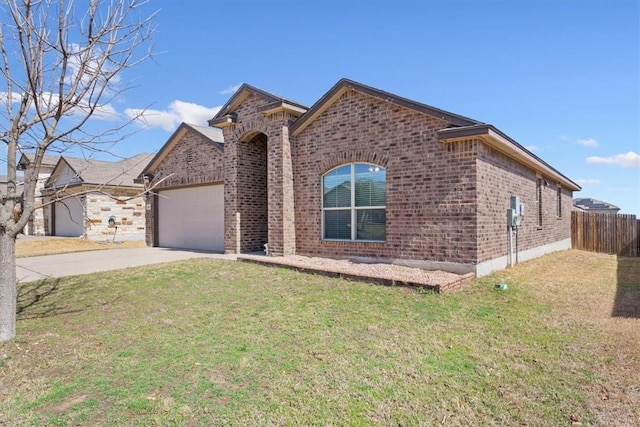 view of front of home with brick siding, a front yard, fence, a garage, and driveway