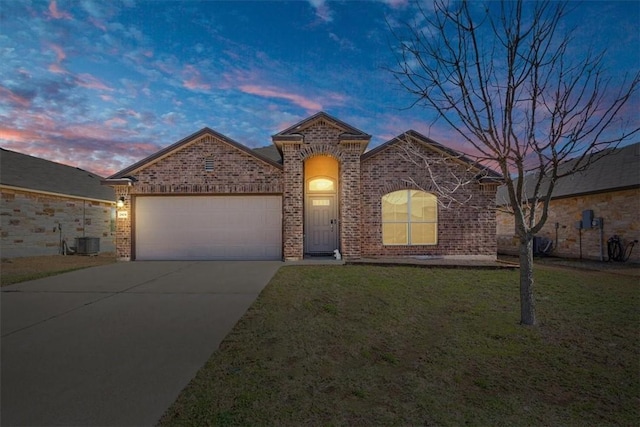 view of front of property with an attached garage, brick siding, concrete driveway, and a front yard