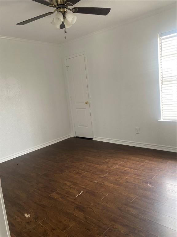 unfurnished room featuring a ceiling fan, baseboards, ornamental molding, and dark wood-type flooring