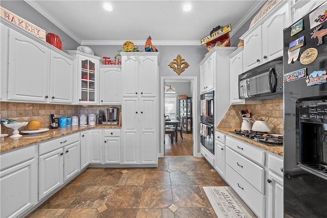 kitchen featuring black appliances, white cabinets, and ornamental molding