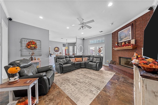 living room featuring crown molding, a fireplace, ceiling fan, and french doors