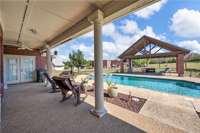 view of swimming pool with a gazebo, ceiling fan, a patio area, and french doors