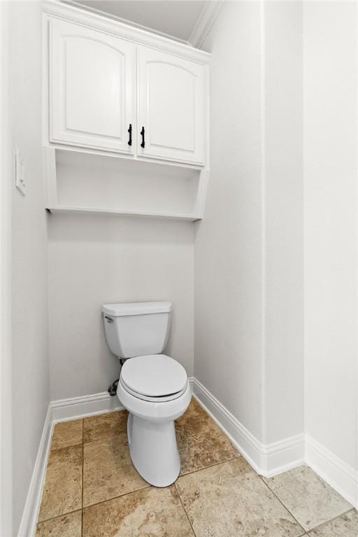 bathroom with toilet and ornamental molding