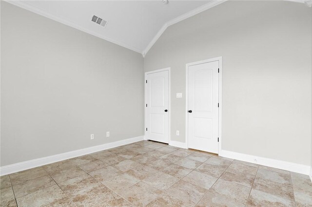 spare room featuring lofted ceiling and crown molding