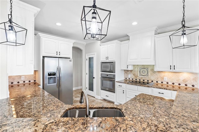 kitchen featuring white cabinetry, sink, pendant lighting, and appliances with stainless steel finishes