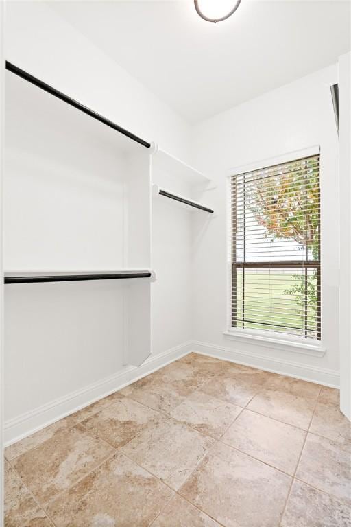 spacious closet featuring light tile patterned flooring