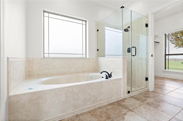 bathroom featuring tile patterned floors and separate shower and tub