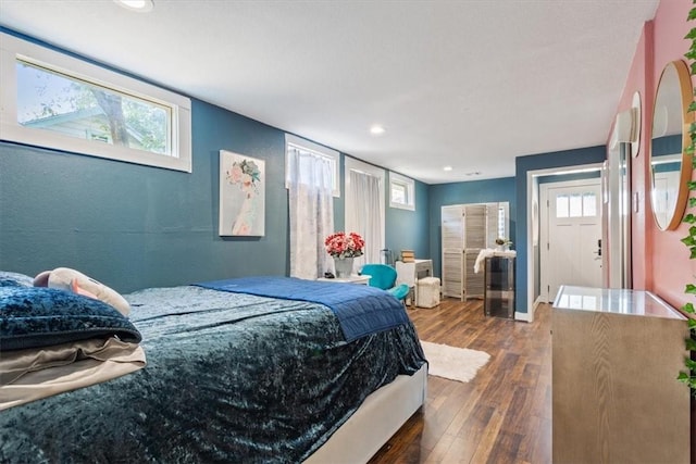 bedroom featuring wood-type flooring, baseboards, and recessed lighting