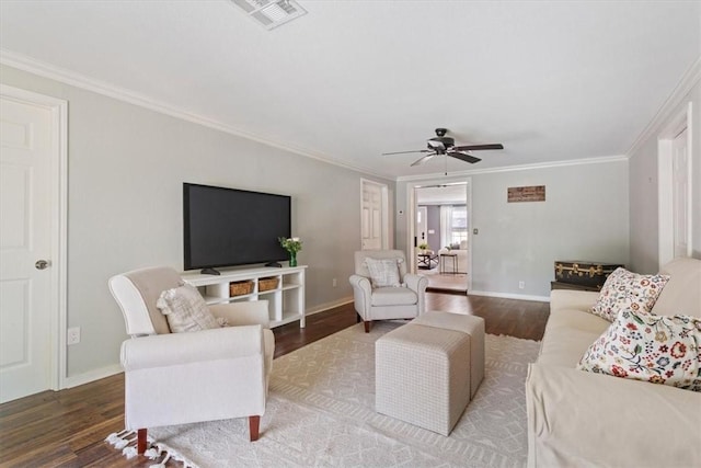 living area with ornamental molding, visible vents, and wood finished floors