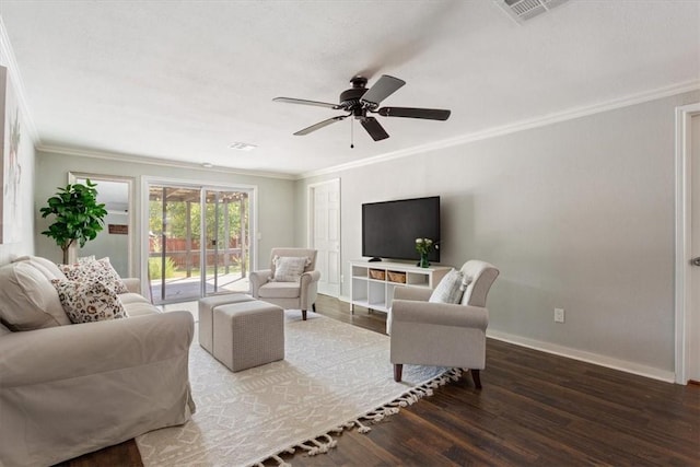 living area featuring crown molding, wood finished floors, visible vents, and baseboards