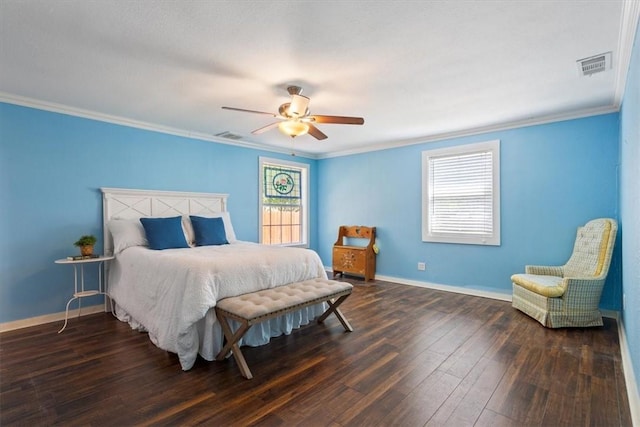 bedroom with hardwood / wood-style floors, multiple windows, visible vents, and crown molding