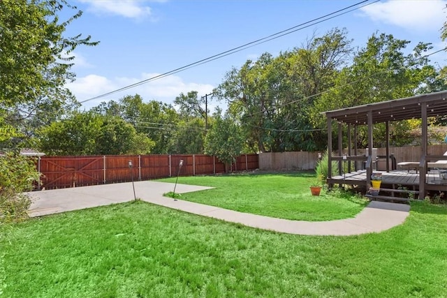 view of yard with a fenced backyard and a wooden deck