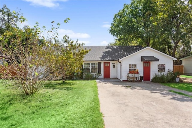 ranch-style house with a front yard and fence