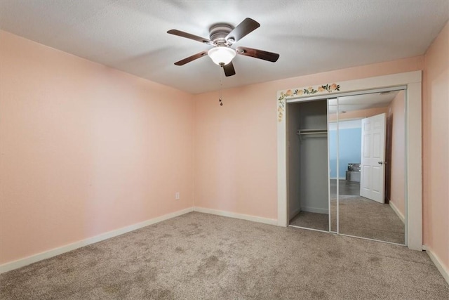 unfurnished bedroom featuring ceiling fan, carpet floors, a closet, and baseboards